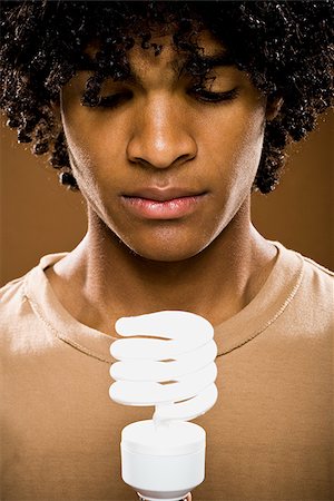 simsearch:640-02776875,k - young man in a brown shirt holding light bulbs. Stock Photo - Premium Royalty-Free, Code: 640-02656877