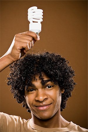 simsearch:640-02776875,k - young man in a brown shirt holding light bulbs. Stock Photo - Premium Royalty-Free, Code: 640-02656878