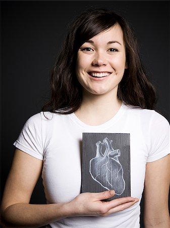 Woman with a drawing of a heart Stock Photo - Premium Royalty-Free, Code: 640-02658472