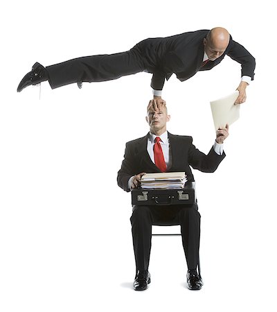 Two male acrobats in business suits performing Stock Photo - Premium Royalty-Free, Code: 640-02764548