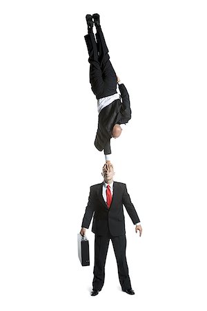 High angle view of two male acrobats in business suits performing Stock Photo - Premium Royalty-Free, Code: 640-02764554