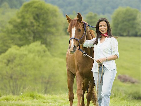 Portrait of a woman standing with a horse Stock Photo - Premium Royalty-Free, Code: 640-02764674