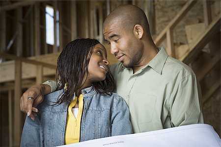 simsearch:640-02764709,k - Portrait of a young couple smiling in a home that is being constructed Stock Photo - Premium Royalty-Free, Code: 640-02764710