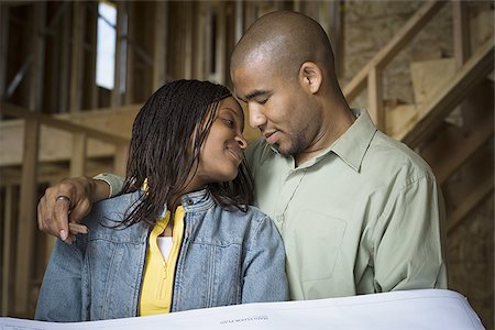 simsearch:640-02764709,k - Portrait of a young couple smiling in a home that is being constructed Stock Photo - Premium Royalty-Free, Code: 640-02764711