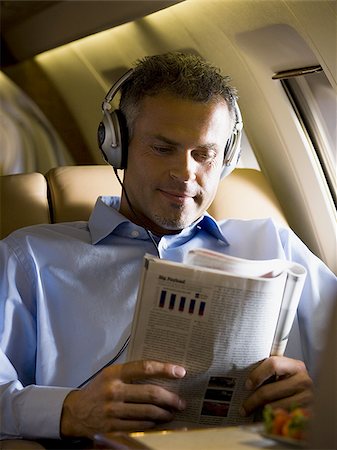 simsearch:640-01350298,k - A senior man reading a magazine in an airplane Stock Photo - Premium Royalty-Free, Code: 640-02764754