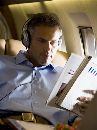 simsearch:640-01350298,k - A senior man reading a magazine in an airplane Stock Photo - Premium Royalty-Free, Code: 640-02764755