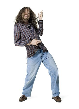 simsearch:640-03265333,k - Young man sticking his tongue out and playing air guitar Stock Photo - Premium Royalty-Free, Code: 640-02764774