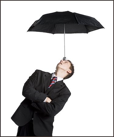 simsearch:640-02768599,k - Businessman balancing umbrella on his forehead Stock Photo - Premium Royalty-Free, Code: 640-02764815