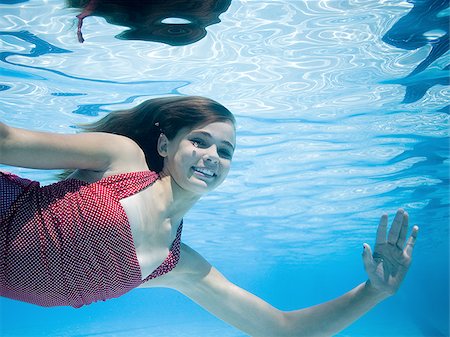 Girl swimming underwater in pool Stock Photo - Premium Royalty-Free, Code: 640-02764895