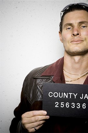 simsearch:640-02771013,k - Mug shot of man with cigarette and gold chains Stock Photo - Premium Royalty-Free, Code: 640-02764986