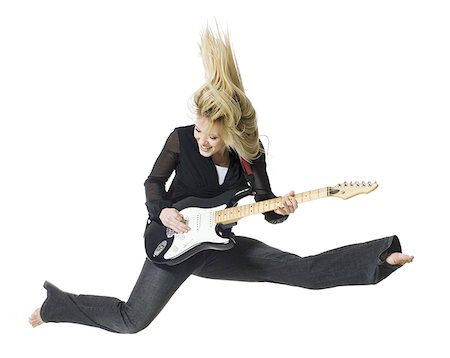 simsearch:640-03259938,k - Profile of woman jumping with electric guitar Stock Photo - Premium Royalty-Free, Code: 640-02765145