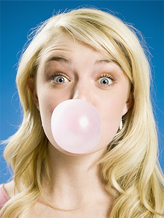 Girl blowing bubble and cross eyed Stock Photo - Premium Royalty-Free, Code: 640-02765192