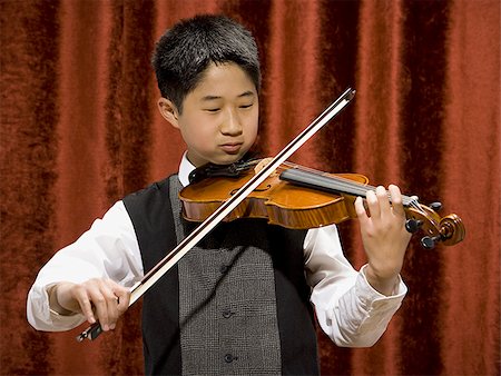 picture of young boy holding violin - Boy playing violin Stock Photo - Premium Royalty-Free, Code: 640-02765248