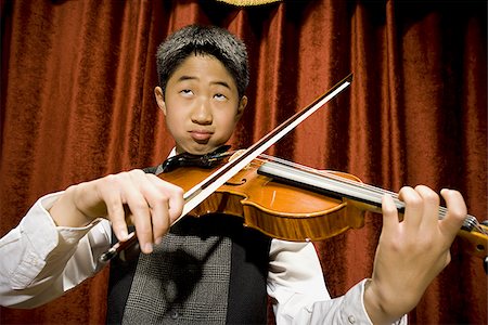 picture of young boy holding violin - Boy playing violin Stock Photo - Premium Royalty-Free, Code: 640-02765251