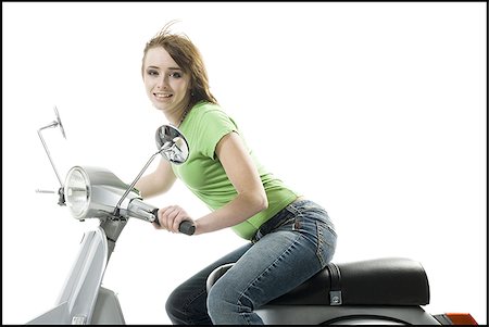 scooter with white background - Portrait of a teenage girl riding a scooter Stock Photo - Premium Royalty-Free, Code: 640-02765819