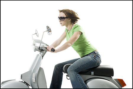 scooter with white background - Profile of a teenage girl riding on a scooter Stock Photo - Premium Royalty-Free, Code: 640-02765823