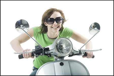 scooter with white background - Close-up of a teenage girl riding a scooter Stock Photo - Premium Royalty-Free, Code: 640-02765834