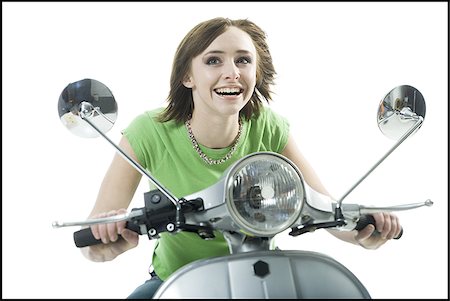 scooter with white background - Close-up of a teenage girl riding a scooter Stock Photo - Premium Royalty-Free, Code: 640-02765833