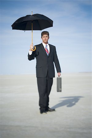 future of the desert - Portrait of a businessman holding an umbrella Stock Photo - Premium Royalty-Free, Code: 640-02766707