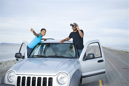 Young man and a young woman standing near a car Stock Photo - Premium Royalty-Free, Code: 640-02766721