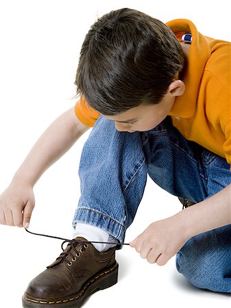 simsearch:700-02756413,k - Close-up of a boy tying his shoelace Stock Photo - Premium Royalty-Free, Code: 640-02766826