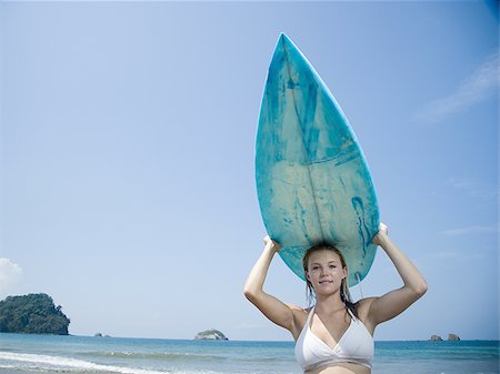 surfboard close up - Portrait of a young woman holding a surfboard over her head Stock Photo - Premium Royalty-Free, Code: 640-02766863