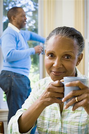 simsearch:640-02767388,k - Close-up of a senior woman holding a cup of coffee with a senior man standing behind her Stock Photo - Premium Royalty-Free, Code: 640-02766915