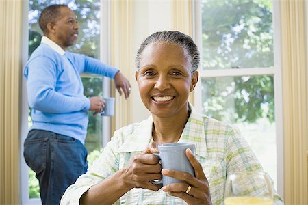 simsearch:640-02767388,k - Close-up of a senior woman holding a cup of coffee with a senior man standing behind her Stock Photo - Premium Royalty-Free, Code: 640-02766911