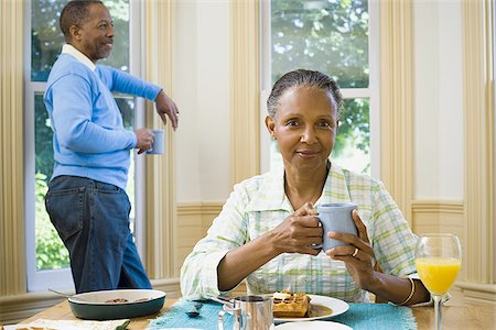 simsearch:640-02767388,k - Close-up of a senior woman holding a cup of coffee with a senior man standing behind her Stock Photo - Premium Royalty-Free, Code: 640-02766912