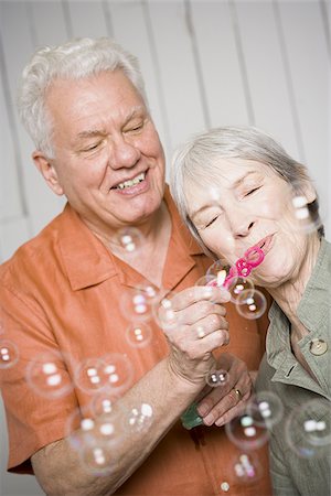 simsearch:640-02768330,k - Close-up of an elderly couple blowing bubbles with a bubble wand Stock Photo - Premium Royalty-Free, Code: 640-02767052