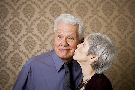 funny old people faces - Close-up of an elderly woman kissing an elderly man Stock Photo - Premium Royalty-Free, Code: 640-02767066