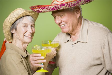 photos of 70 year old women faces - Portrait of an elderly couple holding glasses of lemon juice Stock Photo - Premium Royalty-Free, Code: 640-02767060