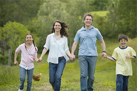 simsearch:640-02767291,k - woman and a man with their son and daughter running in a field Stock Photo - Premium Royalty-Free, Code: 640-02767255