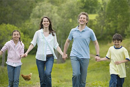 simsearch:640-02767291,k - woman and a man with their son and daughter running in a field Stock Photo - Premium Royalty-Free, Code: 640-02767256