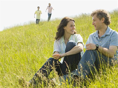simsearch:640-02767388,k - Close-up of a woman and a man sitting together and laughing in a field Stock Photo - Premium Royalty-Free, Code: 640-02767284