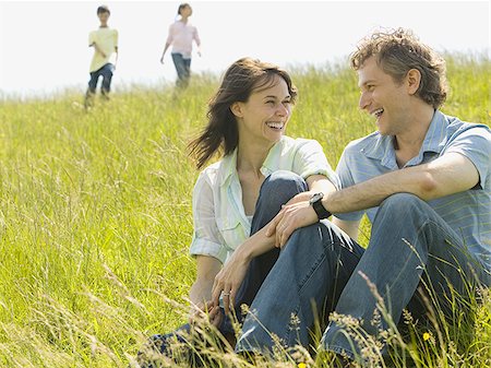 simsearch:640-02767388,k - Close-up of a woman and a man sitting together and laughing in a field Stock Photo - Premium Royalty-Free, Code: 640-02767282