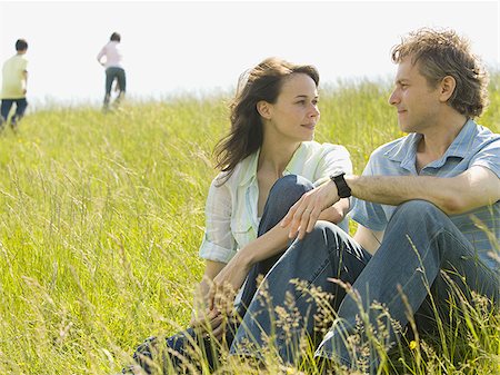 simsearch:640-02767388,k - Close-up of a woman and a man sitting together and laughing in a field Stock Photo - Premium Royalty-Free, Code: 640-02767283