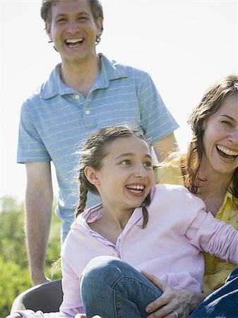 simsearch:640-02767388,k - woman and her daughter sitting in a wheel barrow with a man standing beside them Stock Photo - Premium Royalty-Free, Code: 640-02767298