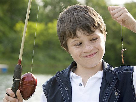 photos of little boy fishing - Portrait of a boy fishing Foto de stock - Sin royalties Premium, Código: 640-02767339
