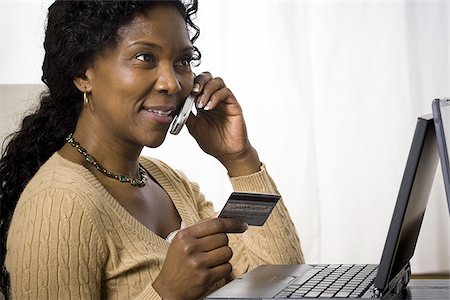 simsearch:640-02767388,k - Profile of a mature woman talking on a mobile phone and holding a credit card Stock Photo - Premium Royalty-Free, Code: 640-02767384