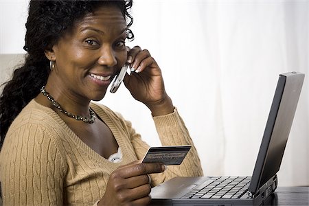 simsearch:640-02767388,k - Profile of a mature woman talking on a mobile phone and holding a credit card Stock Photo - Premium Royalty-Free, Code: 640-02767386