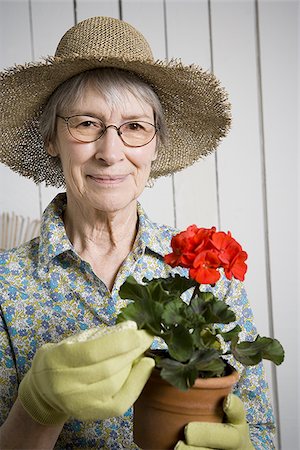 simsearch:640-02768330,k - Portrait of an elderly woman holding a potted plant Stock Photo - Premium Royalty-Free, Code: 640-02767395