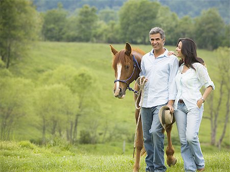 man and a woman walking with a horse Stock Photo - Premium Royalty-Free, Code: 640-02767484