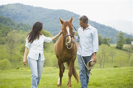 man and a woman with a horse Stock Photo - Premium Royalty-Free, Code: 640-02767487