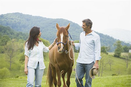 man and a woman with a horse Stock Photo - Premium Royalty-Free, Code: 640-02767488