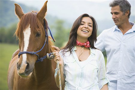 simsearch:640-01356213,k - Portrait of a woman holding the reins of a horse with a man beside her Stock Photo - Premium Royalty-Free, Code: 640-02767495