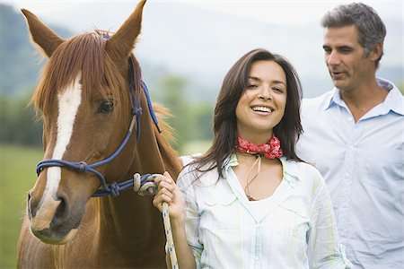 simsearch:640-01356213,k - Portrait of a woman holding the reins of a horse with a man beside her Stock Photo - Premium Royalty-Free, Code: 640-02767497