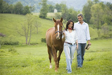 man and a woman walking with a horse Stock Photo - Premium Royalty-Free, Code: 640-02767491