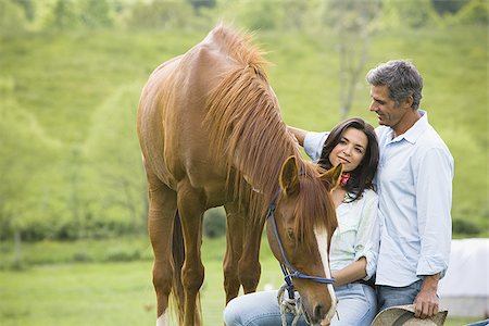 man and a woman standing with a horse Stock Photo - Premium Royalty-Free, Code: 640-02767502