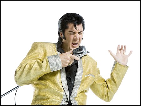 singing funny - An Elvis impersonator singing into a microphone Stock Photo - Premium Royalty-Free, Code: 640-02767597